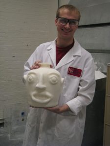 MSOE staff member Jordan Weston shows the finished rapid-prototyped piece constructed of sintered nylon.