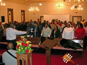 Leon DeBerry shows energy in the directing of the Mass Choir as they practiced at Macedonia Monday evening.