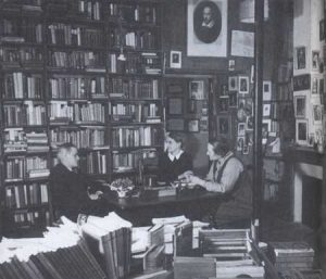 James Joyce, Sylvia Beach, and Adrienne Monnier at Shakespeare and Company, Paris, 1938.  Note the portrait of William Shakespeare at the top of the photograph. Published with permission of Gerry Images.