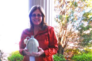 Donna Lybrand with her newly won piece of Edgefield Pottery.