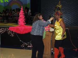 A judge for the STHS Cosmetology Show, Charlotte Cheatham, receives a gift from the cosmetology director Jacqueline Kennion.