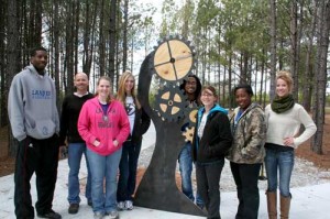 Lander University assistant professor of art Doug McAbee and his advanced sculpture students pose for a photo with the “sensory sculpture” designed by Haley Floyd, a visual art major from Greenwood. Floyd’s sculpture, along with those of her classmates, was recently added to the therapeutic riding trail behind Greenwood’s Burton Center. From left to right are Jermel Kennedy, of Toronto, Canada; McAbee; Samantha Brown, of Spartanburg; Danielle Tavernier, of Greenville; Fred Parker, of Baton Rouge, La.; Floyd; Bethany Murray, of Ware Shoals; and Whitney Price, of Anderson.