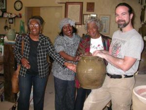 These ladies are touching a Dave pot being held by Justin Guy, potter and the director for the Old Edgefield Pottery Center on Simkins Street, Edgefield.