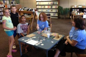 Edgefield Library Staffer Erin Baughcome paints faces as staffer Nancy Asbill looks on.