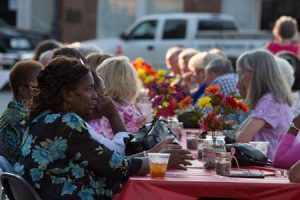 Southern Studies guests await the re-enactors on the square, at a Friday evening Block Party on the square.