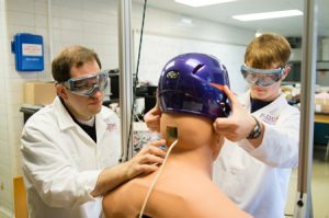 Clemson bioengineering assistant professor David Kwartowitz works with a student Creative Inquiry team conducting research to prevent sports concussions. image by: Craig Mahaffey Clemson University