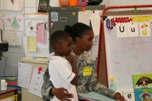 Ammar greets his mother in class.