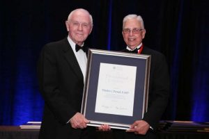 Dr. Derrick left) is presented the Presidential Citation at recent AUA meeting.
