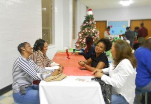 NFL Players’ moms Tracey Hamilton, Angela Watson (both sons play for the Dallas Cowboys) and Delores Hazel, whose son plays with Miami Dolphins, interacts with the ECYEC  volunteer Geneva Gomillion.