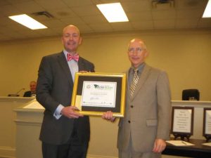 Will Williams presents outgoing Chairman Campbell a plaque indicating a work-ready county