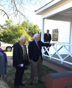 Ambassador Cooper points to the building; he and his family gave the building and grounds.