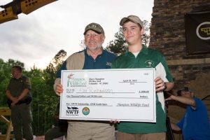 NWTF CEO George Thornton presents an NWTF scholarship to youth participant, Alex Richardson 