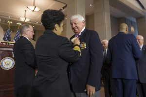Frank Feltham is photographed being pinned, the pin noting “A Grateful Nation Thanks and Honors You.” Submitted photo