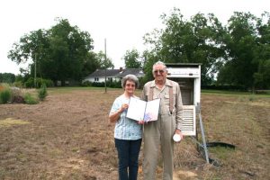 Mr. and Mrs. Olin Berry hold 35 year service award presented to Olin last Friday at the Berry residence in Johnston, south Carolina.