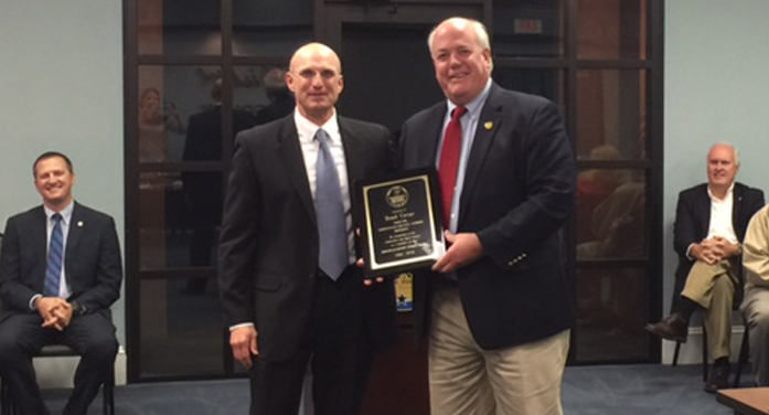 Dr. Robert Maddox, ECSD Superintendent presents Brad Covar plaque recognizing twenty-four years of service.