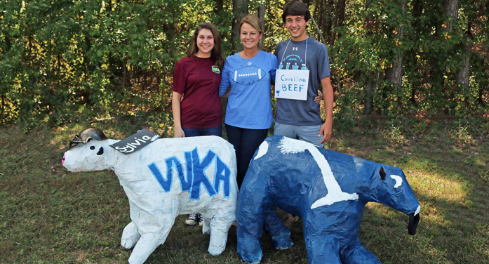 Pictured left to right with their WKA and Palmetto Flag cows are Gracie Holsenback, Mrs. Angie Sanders, and Truman Caughman.”